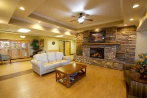 Seating area by fireplace in lobby at Copper Ridge Health and Rehab