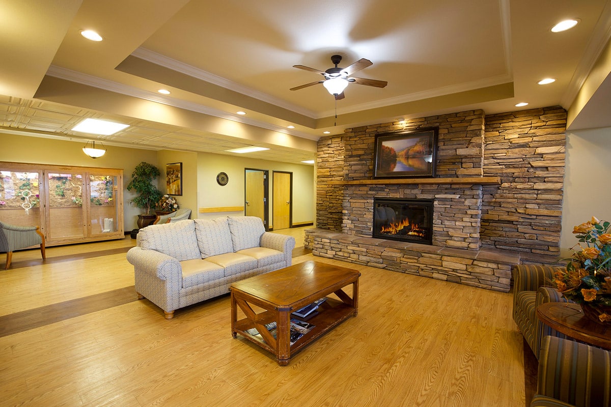 Seating area by fireplace in lobby at Copper Ridge Health and Rehab